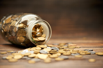Glass jar filled of golden coins