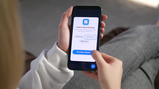 Woman uses mobile trading app to confirm stock purchase at home. Selecting shares, processing transaction and successful investment notification on screen. Modern fintech, online banking and digital