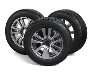 Obraz premium Three car tires with alloy wheels, isolated on a white background, close up shot