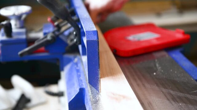 Carpenter operate electric Thickness Planer remove excess wood with. Wood shaping, precision cut, workshop tool, material trim, professional skill, surface smoothing