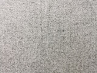 High-quality close-up of a seamless grey felt texture with a soft, heathered finish. The dense, non-woven fibrous surface creates a clean, neutral background perfect for minimalist design, industrial 