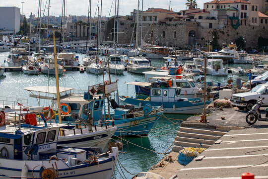 Yachts and sailboats at the pier local marina on beautiful sunny day in Heraklion, Greece