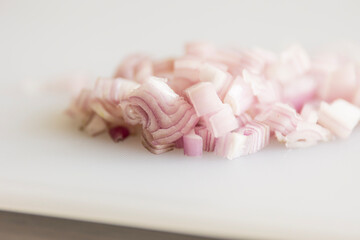 Slicing Shallot Onion on White Cutting Board &ndash; Close-Up