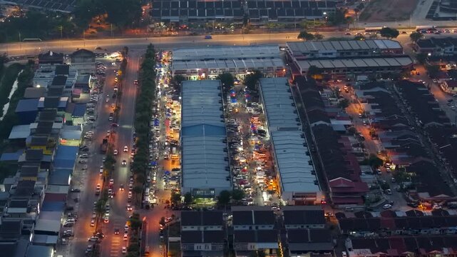 Aerial view of Taman Tangling pasar malam at night shows bustling stalls, diverse food offerings, and lively crowds in festive atmosphere.