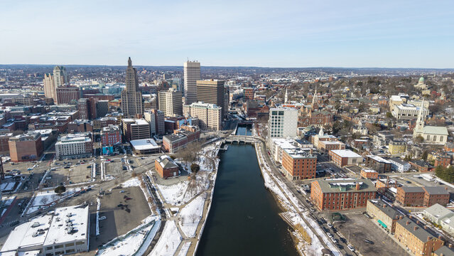 Aerial view of the Providence River cutting through the city's heart near the iconic Superman Building, a tapestry of modern and historic architecture, Providence, Rhode Island, United States.