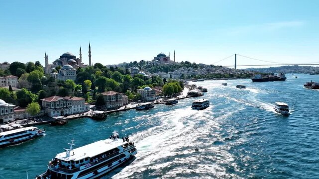 Istanbul city skyline along Bosphorus with boats and Hagia Sophia