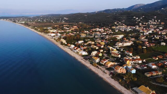 Aerial drone view of Acharavi beach, coast sea village settlement, Thinali, Agios Panteleimonas, North Corfu island, Ionian Islands, Kerkyra, Greece in a summer sunny day with villas, town, sandy beac
