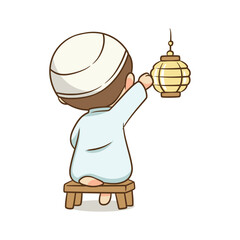 Boy in Islamic dress hanging traditional lantern lamp while sitting stool