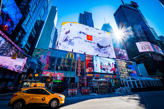 Breathtaking, stunning view of Times Square in New York City, NY, USA, with bright, illuminated ads on billboards and tall skyscrapers all around