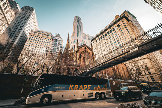 Beautiful view of Trinity Church, nestled among the tall skyscrapers of Lower Manhattan in New York City, NY, USA, on a sunny but cold winter day