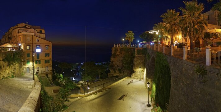 Sea view panorama with the medieval old town of Tropeain the evening twilight, Belvedere Piazza del Cannone, Tropea, Calabria, Vibo Valentia, Southern Italy, Italy