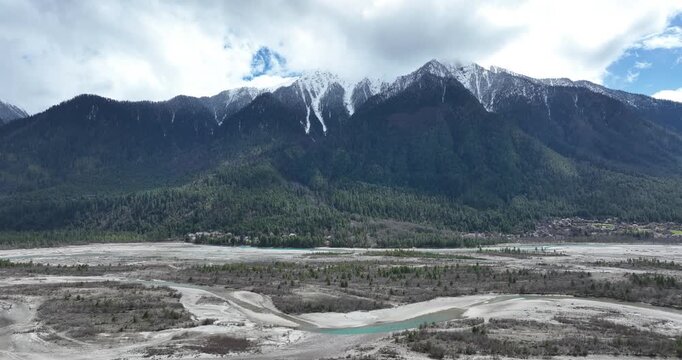 Aerial footage of high altitude snow mountains and forest in tibet, China