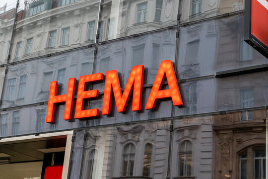 Vienna, Austria- Feb 21, 2026: HEMA store sign glowing brightly against a modern building facade, embodying a blend of architecture and commerce in the vibrant city.