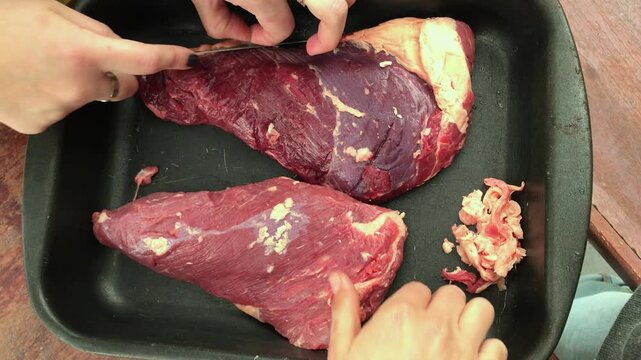 Seasoning Raw Beef for Argentine Barbecue &ndash; Hands Preparing Meat for Traditional Asado Grill