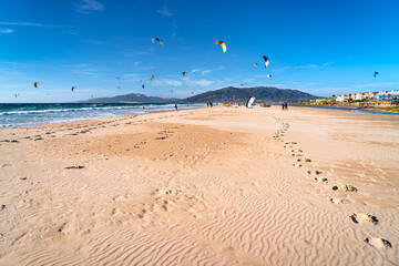 Kitesurfing on beach on sunny day, Tarifa holiday in Andalusia, holiday in Spain. © Tomasz