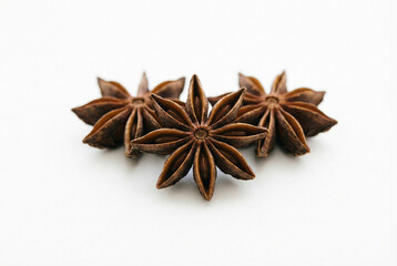 Star anise spice with three whole pods on a white background  