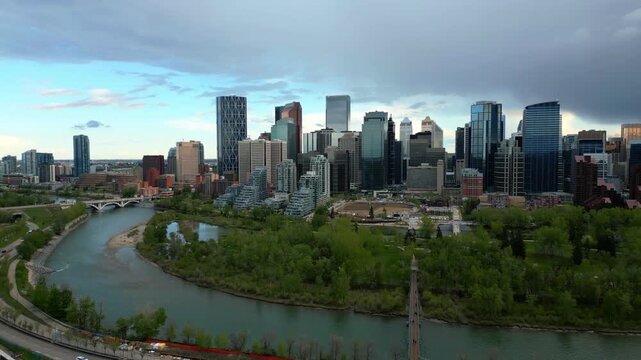 Calgary drone aerial view of skyline with modern skyscrapers lining the Bow River in Alberta, Canada