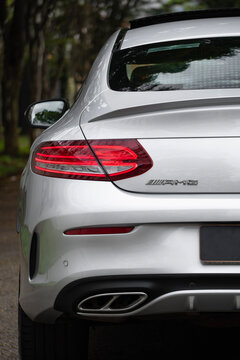 Silver Mercedes-AMG C43 rear taillight and AMG badge close up, Luxury performance car external detail