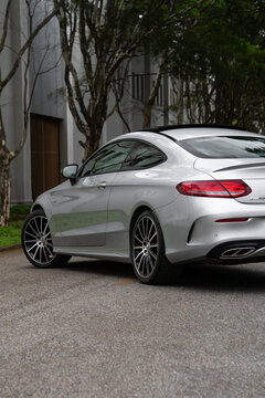 Silver Mercedes-AMG C43 rear side view, Luxury performance sedan external shot
