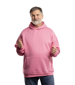 Handsome mature man with beard wearing casual pink sweatshirt over transparent background. Very happy and excited, doing winner gesture with arms raised, smiling and screaming for success