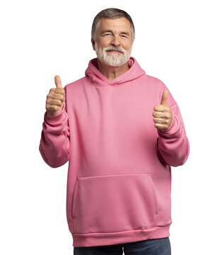 Attractive cheerful mature man wearing pink sweatshirt standing isolated over transparent background, showing thumbs up