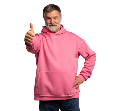 Attractive cheerful mature man wearing pink sweatshirt standing isolated over transparent background, showing thumbs up