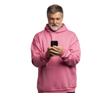 Smiling mature man wearing pink sweatshirt looking at smartphone, isolated on transparent