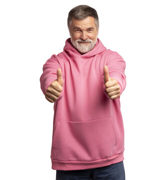 Attractive cheerful mature man wearing pink sweatshirt standing isolated over transparent background, showing thumbs up