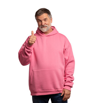 Attractive cheerful mature man wearing pink sweatshirt standing isolated over transparent background, showing thumbs up