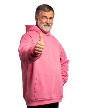 Attractive cheerful mature man wearing pink sweatshirt standing isolated over transparent background, showing thumbs up