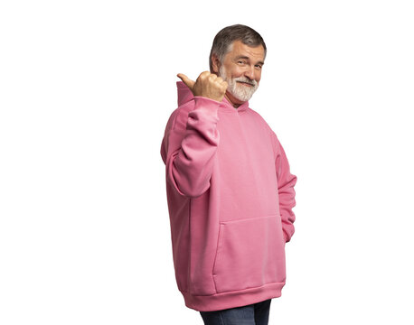 Attractive cheerful mature man wearing pink sweatshirt standing isolated over transparent background, showing thumbs up