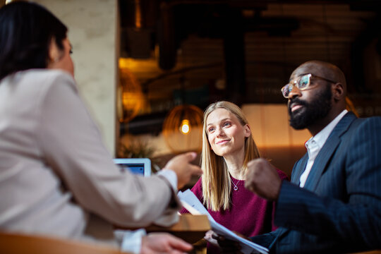 Couple consulting financial advisor in cafe