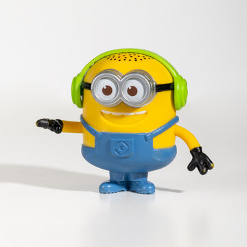 Minions action figure wearing headphones playing music