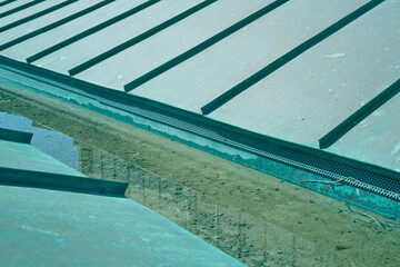 Obraz premium Green copper roof due to oxidation of the material with rainwater collection channel