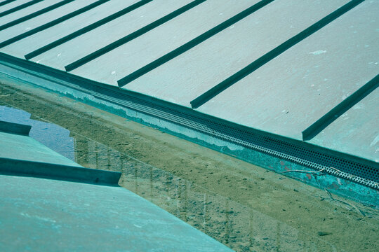 Green copper roof due to oxidation of the material with rainwater collection channel
