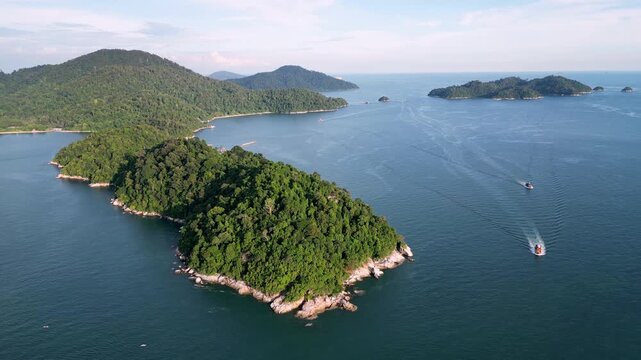 Aerial shot highlights Pulau Pangkor forested hills, dense greenery contrasting with bright beaches and clear sea.