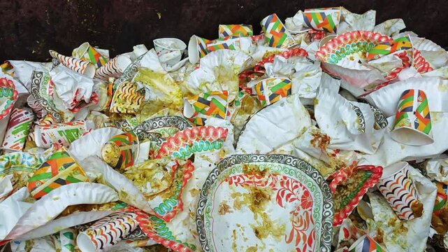 Large pile of used disposable paper plates discarded