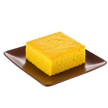 Golden cornbread square on brown plate textured surface isolated on white background