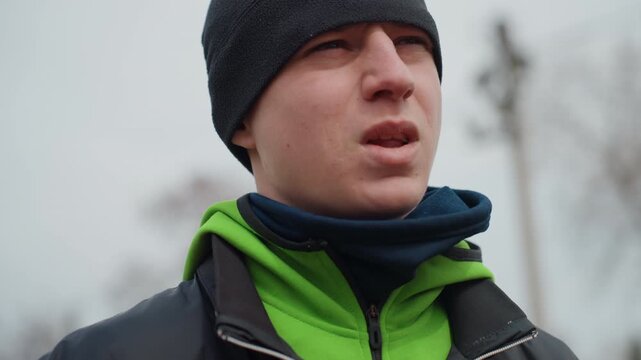 icecold pensive gaze, introspective male portrait captured in muted winter lighting conditions, contemplative male image outdoors during winter with subtle emotional undertones and soft lighting