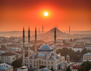 Fototapeta premium A stunning cityscape at sunrise or sunset features a large mosque dominating the foreground