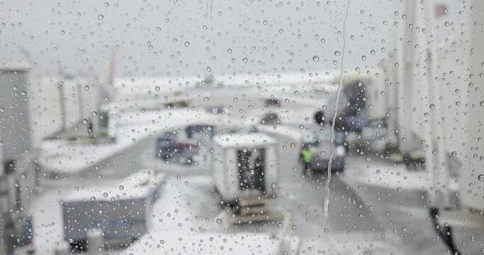 Snow Covered Tarmac at Boston Airport focus on window water Drops