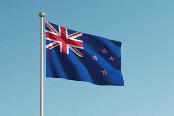 Fototapeta premium New Zealand national flag waving on pole against clear blue sky background.