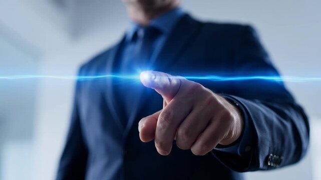 Businessman in blue suit touching blue light line with finger in office
