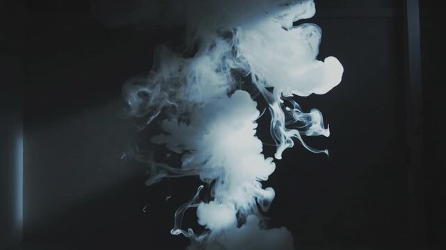 White smoke swirling in dark background with light beam