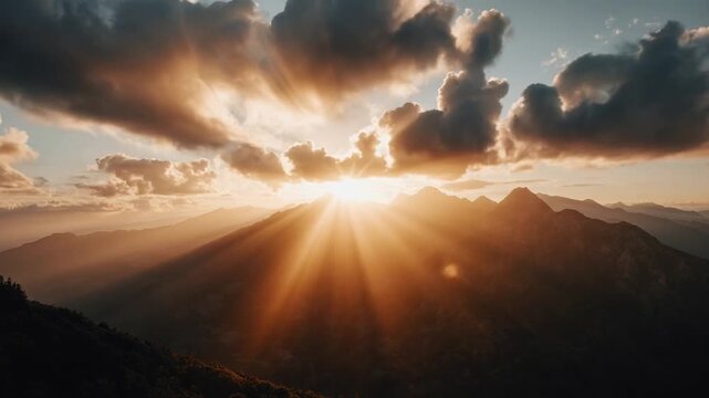 Dramatic sunset with radiant sun rays over silhouetted mountains and warm glowing sky. Cinematic light beams and atmospheric clouds, perfect for inspirational and nature themes.
