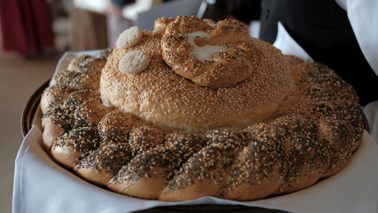 Traditional Slavic bread loaf used for welcoming guests and celebrations decorated with sesame and...
