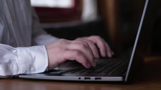 Caucasian Man Typing Report On Laptop In White Shirt, Crisp Cuff Hands Moving Across Keys, Professional Atmosphere, Careful Editing And Document Preparation In Quiet Office