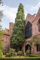 Visit to a historic garden in a brick courtyard featuring tall trees and small stone sculptures under a blue sky with some clouds