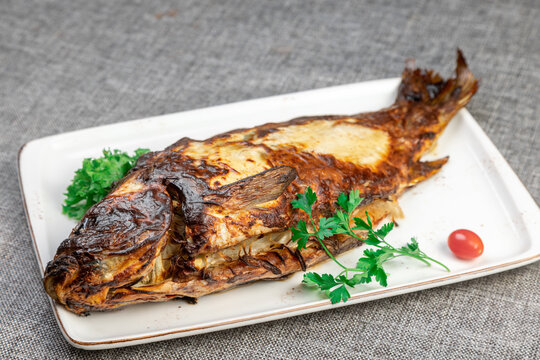 Macro Photo of Fried Carp: Crispy Texture, Rustic Serving, Natural Light
