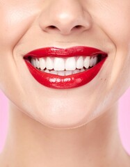 Naklejka premium Radiant Smile - A Close-Up of Perfect Teeth and Red Lipstick.